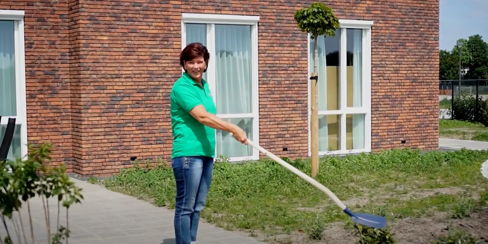 Het Beekdalhuis daagt je uit om de shovel challenge mee te doen een collega tilt zo de schep op