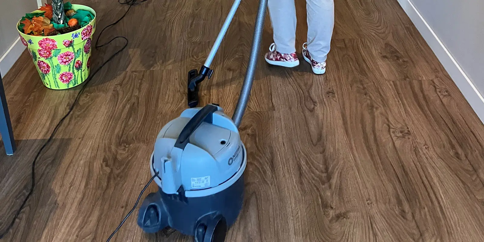 Een bewoner helpt stofzuigen in de kleinschalige woonzorglocatie voor mensen met dementie.